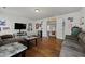 Comfortable living room with hardwood floors, features a large TV and sofa seating at 2015 Chapel Estates Lane Southeast Ln, Dacula, GA 30019