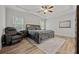 Bright main bedroom with tray ceiling, and a cozy chair seating area at 2015 Chapel Estates Lane Southeast Ln, Dacula, GA 30019
