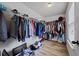 Functional walk-in closet providing lots of storage on racks and shelves for clothing, shoes, and accessories at 2015 Chapel Estates Lane Southeast Ln, Dacula, GA 30019