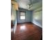 A bedroom with hardwood floors, ceiling fan, and a window at 2169 Tiffany Ln, Lithonia, GA 30058