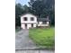 Two-story home featuring a quaint front porch and a driveway at 2169 Tiffany Ln, Lithonia, GA 30058