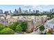 This aerial view showcases the complex with city views and beautiful landscaping at 390 17Th Nw St # 4031, Atlanta, GA 30363