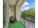 Private balcony with green turf, black railing, outdoor chair, and scenic neighborhood views at 390 17Th Nw St # 4031, Atlanta, GA 30363