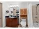 Well-lit bathroom with a single sink vanity, walk-in closet, shower, and toilet at 390 17Th Nw St # 4031, Atlanta, GA 30363