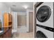Modern bathroom with washer and dryer, shower, vanity, toilet, and storage cabinets at 390 17Th Nw St # 4031, Atlanta, GA 30363