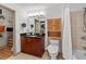 Well-lit bathroom with a walk-in closet, single sink vanity, shower, and toilet for convenience at 390 17Th Nw St # 4031, Atlanta, GA 30363