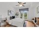 Bright bedroom featuring a bed with large pillows, a ceiling fan, and balcony access at 390 17Th Nw St # 4031, Atlanta, GA 30363