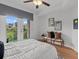 Cozy bedroom with a ceiling fan, balcony access, and neutral decor evokes relaxation at 390 17Th Nw St # 4031, Atlanta, GA 30363