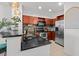 Modern kitchen featuring granite countertops, stainless steel appliances, and warm wood cabinetry at 390 17Th Nw St # 4031, Atlanta, GA 30363