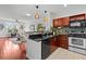 Open-concept kitchen view to living room with granite countertops, stainless steel appliances and hardwood floors at 390 17Th Nw St # 4031, Atlanta, GA 30363