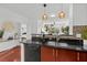 Modern kitchen with granite countertops, warm cabinetry and an open view into the living area at 390 17Th Nw St # 4031, Atlanta, GA 30363