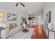Open-concept living room featuring hardwood floors, neutral furniture, and a view into the modern kitchen at 390 17Th Nw St # 4031, Atlanta, GA 30363