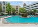 Inviting community pool featuring crystal clear water, sun loungers, and a beautiful landscape at 390 17Th Nw St # 4031, Atlanta, GA 30363