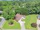 Aerial view of a home with mature trees, long driveway, and well-maintained lawn, offering a private retreat at 401 Crosshaven Way, Mcdonough, GA 30253