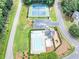 Overhead view of a pool and tennis courts, highlighting community amenities with lush landscaping at 401 Crosshaven Way, Mcdonough, GA 30253