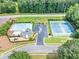 Aerial view of community pool, tennis courts, and parking area, showcasing the neighborhood amenities at 401 Crosshaven Way, Mcdonough, GA 30253