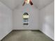 Vaulted bedroom features a single window, neutral paint, and carpet flooring at 401 Crosshaven Way, Mcdonough, GA 30253