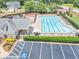 Aerial view of community pool area, with lounge chairs, clubhouse, and parking, perfect for relaxation at 401 Crosshaven Way, Mcdonough, GA 30253