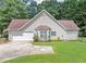 Charming home exterior features a two-car garage and manicured lawn, creating an inviting curb appeal at 401 Crosshaven Way, Mcdonough, GA 30253