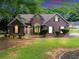 Charming brick home featuring a manicured lawn and mature landscaping, creating a welcoming curb appeal at 401 Crosshaven Way, Mcdonough, GA 30253