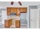 Kitchen featuring wooden cabinets, laminate countertops, tile flooring, and a microwave with a range hood at 401 Crosshaven Way, Mcdonough, GA 30253