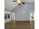 View of a bright living room featuring wood flooring and large window at 401 Crosshaven Way, Mcdonough, GA 30253
