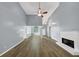 Spacious living room featuring wood flooring, fireplace and abundant natural light at 401 Crosshaven Way, Mcdonough, GA 30253