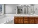Main bathroom featuring double vanity, soaking tub, and separate shower at 401 Crosshaven Way, Mcdonough, GA 30253