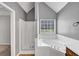 Main bathroom featuring soaking tub and walk-in shower at 401 Crosshaven Way, Mcdonough, GA 30253