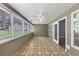 Inviting sunroom, featuring a ceiling fan and many windows overlooking the backyard at 401 Crosshaven Way, Mcdonough, GA 30253