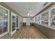 Bright sunroom with multiple windows, tiled floor and outdoor access at 401 Crosshaven Way, Mcdonough, GA 30253