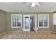 Bright sunroom featuring tiled floor and a door leading inside the home at 401 Crosshaven Way, Mcdonough, GA 30253