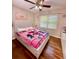 Charming bedroom featuring a ceiling fan and hardwood floors, creating a warm, inviting atmosphere at 507 Legacy Park Ln, Powder Springs, GA 30127