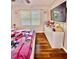 Well-lit bedroom featuring hardwood floors, a mounted TV, and ample storage space at 507 Legacy Park Ln, Powder Springs, GA 30127