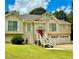 Beautiful home with pristine lawn, shutters, a red front door and a two car garage at 507 Legacy Park Ln, Powder Springs, GA 30127