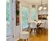 Eat-in kitchen area offers natural light, modern chandelier, and hardwood floors at 507 Legacy Park Ln, Powder Springs, GA 30127