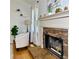 Inviting living room featuring a stone fireplace, decorative mantel, and natural light at 507 Legacy Park Ln, Powder Springs, GA 30127