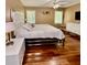 Main bedroom features gleaming hardwood floors and a plush bed with custom headboard at 507 Legacy Park Ln, Powder Springs, GA 30127