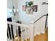 Bright staircase with white railings, decorative wall art, and a modern chandelier at 507 Legacy Park Ln, Powder Springs, GA 30127