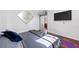 Modern bedroom featuring an accent mirror, tv, and stylish roll-up door at 1231 Barnes Nw St, Atlanta, GA 30318