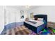 The bedroom is modern and inviting with its hard-wood furniture, artistic epoxy floors, and sleek design at 1231 Barnes Nw St, Atlanta, GA 30318