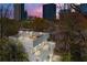 Modern home with a rooftop deck that features stylish outdoor seating and a stunning cityscape view at dusk at 1231 Barnes Nw St, Atlanta, GA 30318