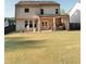 Spacious backyard featuring a covered patio with seating and an expansive lawn at 126 Jacobs Ln, Loganville, GA 30052
