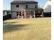 A large backyard features a covered porch perfect for outdoor entertaining and relaxation at 126 Jacobs Ln, Loganville, GA 30052