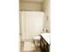 Well-lit full bathroom with modern vanity, shower with curtain, and neutral walls at 126 Jacobs Ln, Loganville, GA 30052
