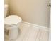 A half bathroom featuring white toilet with white tile flooring and neutral walls at 126 Jacobs Ln, Loganville, GA 30052