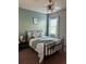 Bedroom with lots of natural light featuring carpeted floors, light-green walls, and neutral decor at 126 Jacobs Ln, Loganville, GA 30052