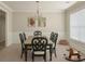 Formal dining room with classic black chairs and table, molding, and a bright window at 126 Jacobs Ln, Loganville, GA 30052