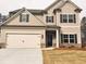 Charming two-story home featuring a two-car garage and a well-maintained front lawn at 126 Jacobs Ln, Loganville, GA 30052