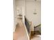 Upstairs hallway boasting neutral walls, a chandelier, and iron railing at 126 Jacobs Ln, Loganville, GA 30052